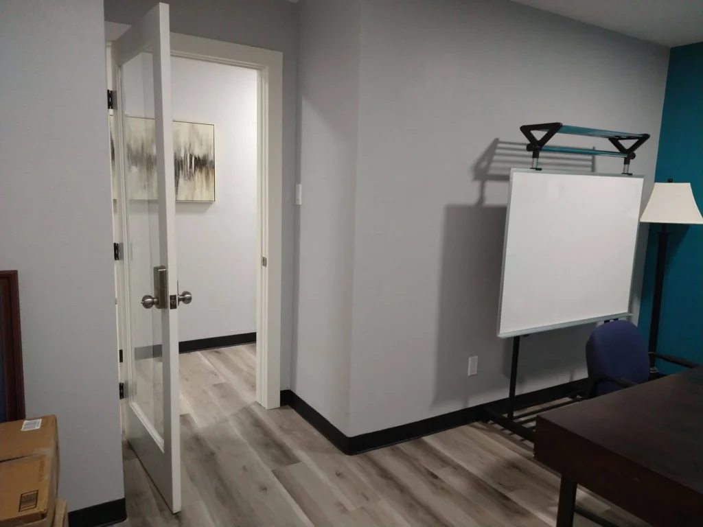 Private office, Suite C, with coded entry glass door, mobile whiteboard, and lamp