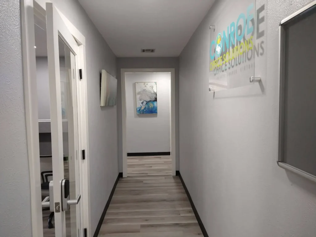 Hallway from Suite A1, with door to front lobby at the left and hallway with restrooms at the far end