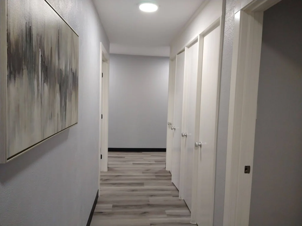 Back hallway with many doors for storage areas